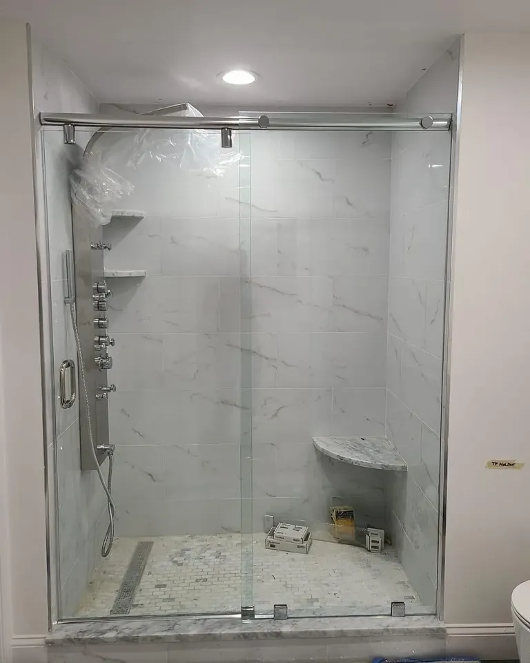 Sliding shower doors with a top rail