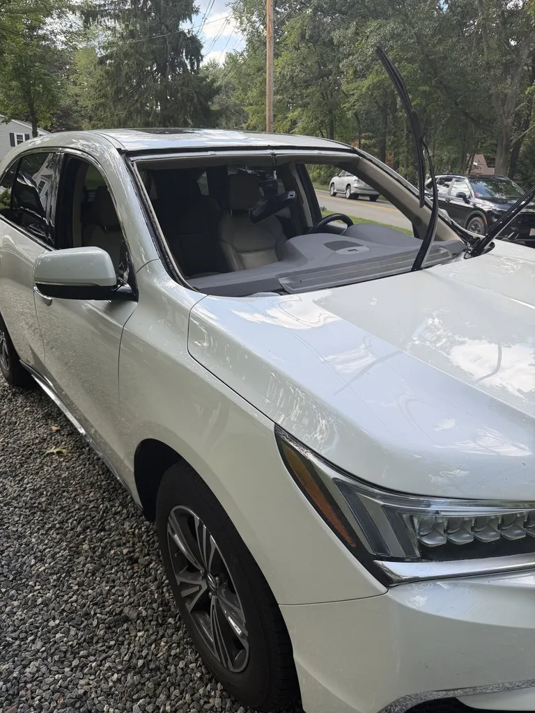 The same Acura MDX with its windshield removed during replacement