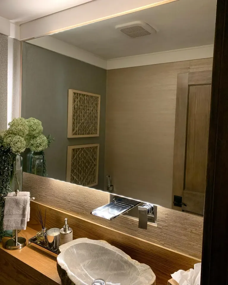 Wall mirror above a bathroom vanity