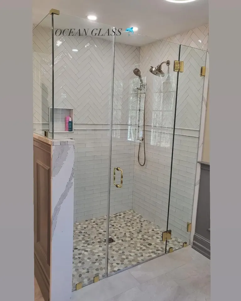 Shower glass with gold-tone hardware
