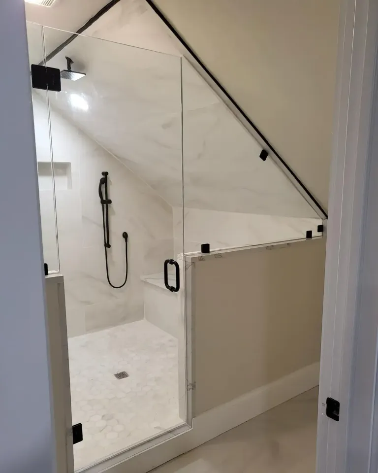 Custom shower glass below an angled ceiling