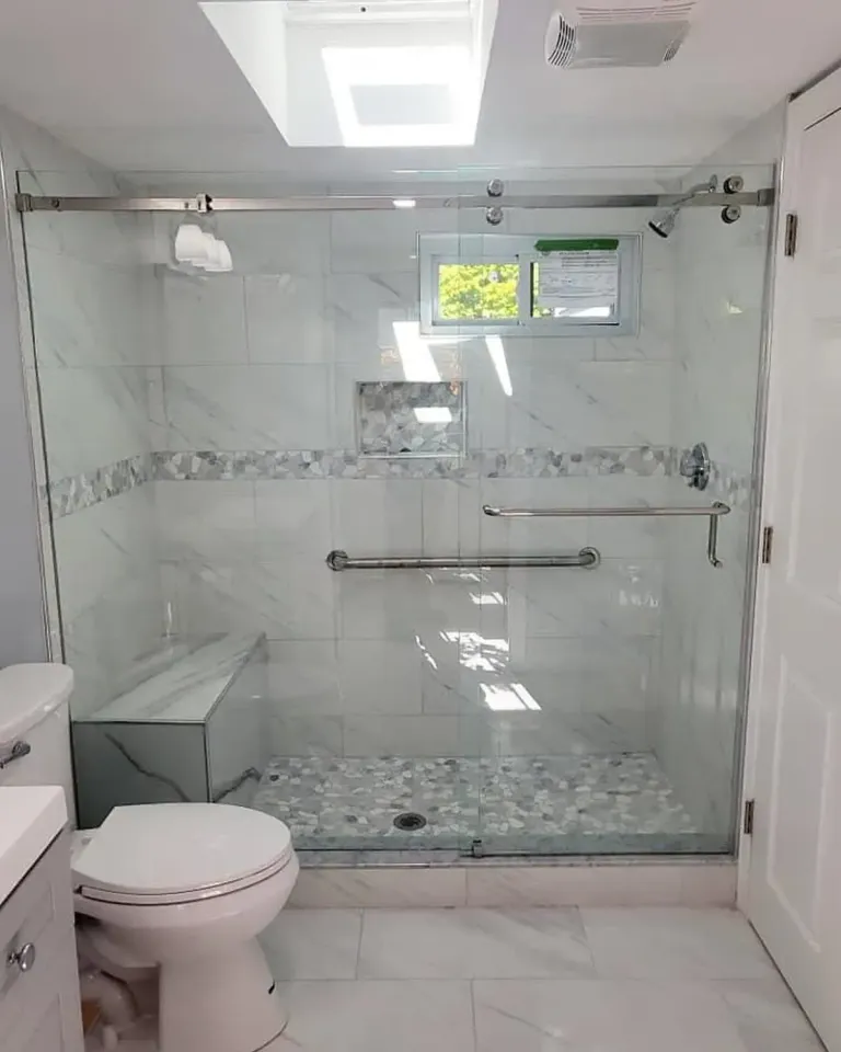 Sliding shower glass below a skylight