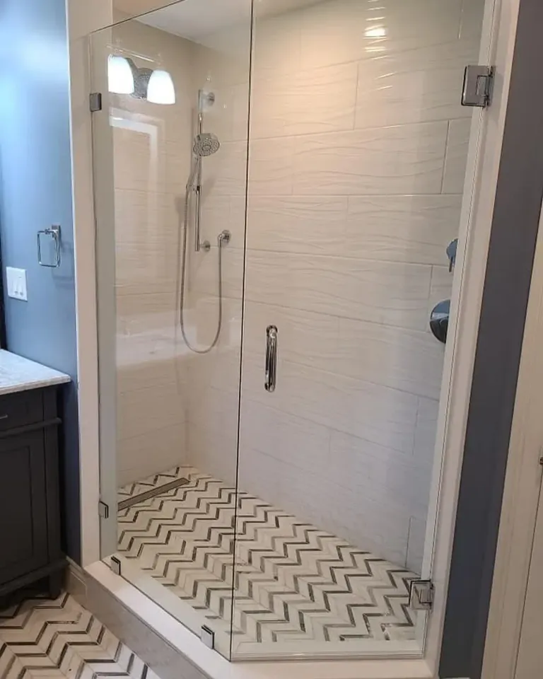 Hinged glass door in a tiled shower