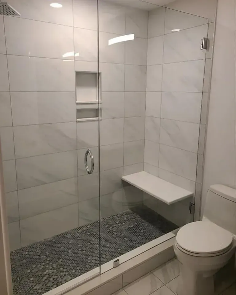 Hinged glass across a shower opening