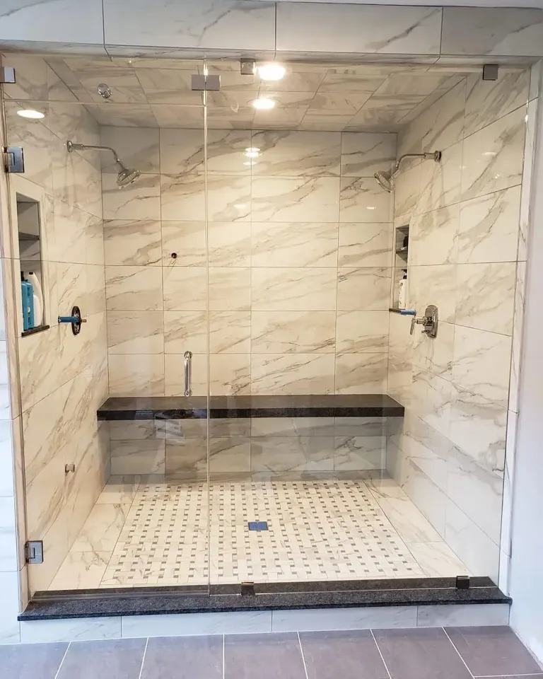 Glass enclosure beside marble-patterned tile