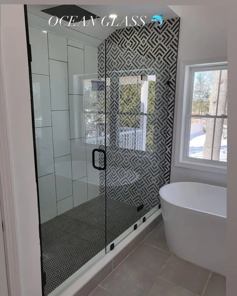 Shower glass beside a freestanding bathtub