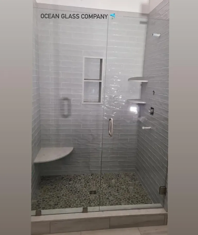 Clear glass across a tiled shower opening