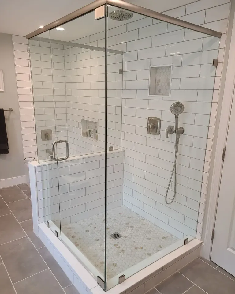 Corner shower enclosure with a support header