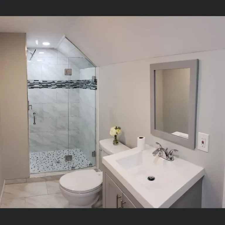 Bathroom shower glass beside a vanity