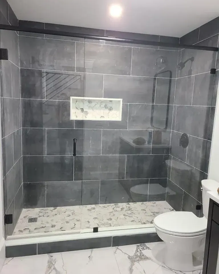 Sliding shower doors with dark hardware