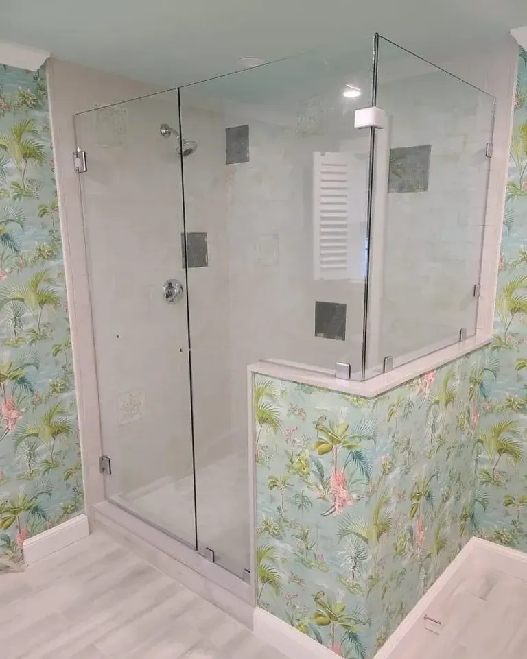 Corner shower glass beside a half wall