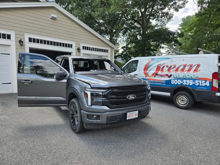 Ford pickup during windshield replacement beside the Ocean Glass mobile service van