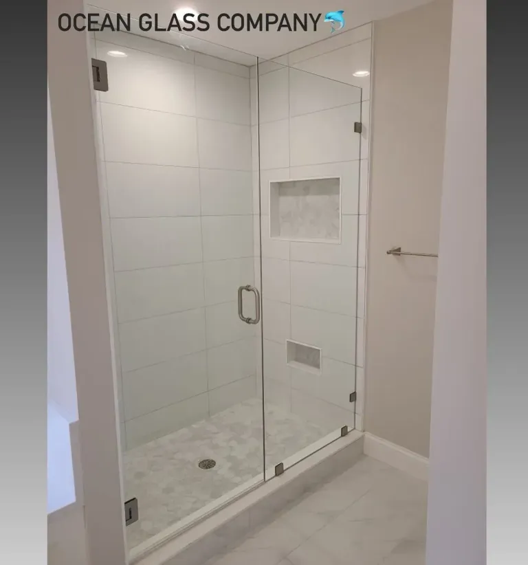 Clear shower door across a tiled opening